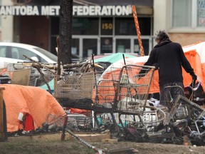 A man is seen in a homeless encampment near the Manitoba Metis Federation headquarters in Winnipeg on Mon., June 8, 2020.