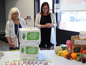 Families Minister Heather Stefanson (right) shows Carol Sanoffsky, Bayline Regional Roundtable co-ordinator, some of the healthy options available for a home nutrition pilot project following a press conference at Ma Mawi Wi Chi Itata Centre on King Street in Winnipeg on Monday.