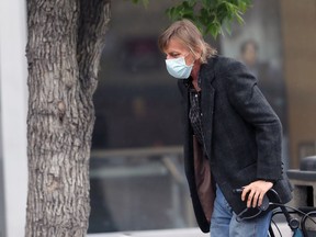 A man wears a mask on Portage Avenue in Winnipeg on Thursday.