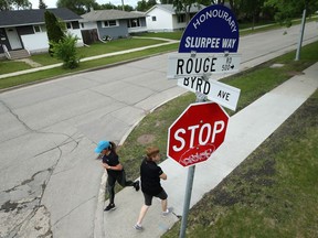 People pass an honourary street name sign in Winnipeg on Mon., June 22, 2020. A community committee has voted to keep the title for two more years. Kevin King/Winnipeg Sun/Postmedia Network
