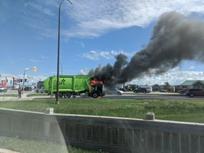 A passing motorist photographed a Green For Life Environmental garbage truck on fire at Lindenwood Drive East and Kenaston Blvd in Winnipeg at shortly after 11:30 a.m., on Tuesday.
