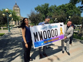 Crown Service Minister Jeff Wharton (right), along with Suzanne and Marco Suzio, display a Madox's Warriors license plate during a press conference on the Manitoba Legislative Building grounds in Winnipeg on Wed., June 24, 2020. The Suzio's son Madox died in 2014 at age 9 after a short battle with a rare pediatric brain cancer. Kevin King/Winnipeg Sun/Postmedia Network