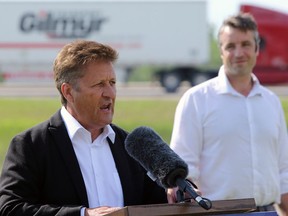 Infrastructure Minister Ron Schuler speaks during a press conference, with Andrew Smith (Lagimodiere) looking on, at Maple Grove Park to announce a new interchange on the Perimeter Highway at St. Mary's Road in Winnipeg on Monday, June 29, 2020.
