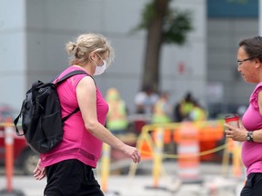 Women in pink walk on Portage Avenue in Winnipeg on Thurs., June 30, 2020. Kevin King/Winnipeg Sun/Postmedia Network