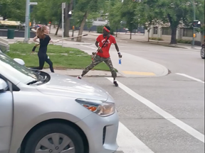A pair of people who participated in a protest on July 4 and were walking east on Broadway were attacked by a woman with a hockey stick, as shown in this screengrab from a Facebook video.