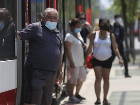 Riders leave a TTC streetcar on Spadina Ave., at at Queen St. W. on July 2, 2020.