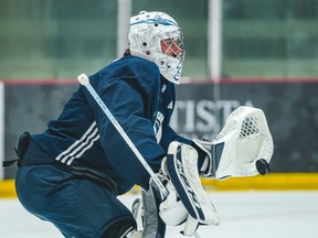 Jets goalie Connor Hellebuyck makes a stop during practice this week.