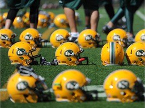 Edmonton Eskimos helmets line the field in this file photo from 2014 training camp.