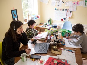 Six-year-old Leo (R) and his three-year old brother Espen (C) complete homeschooling activities suggested by the online learning website of their infant school, as his mother Moira, an employee of a regional council, works from home in the village of Marsden, near Huddersfield, northern England on May 15, 2020, during the novel coronavirus COVID-19 pandemic.