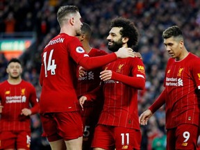 Liverpool's Mohamed Salah celebrates scoring their third goal with Jordan Henderson and teammates REUTERS/Phil Noble EDITORIAL USE ONLY. No use with unauthorized audio, video, data, fixture lists, club/league logos or "live" services. Online in-match use limited to 75 images, no video emulation. No use in betting, games or single club/league/player publications. Please contact your account representative for further details./File Photo ORG XMIT: FW1