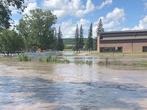 The Little Saskatchewan River floods Tanner’s Crossing Elementary School grounds in Minnedosa, Man., on July 2, 2020.