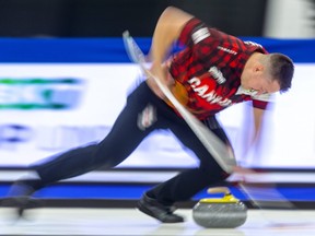 Under Curling Canada's 
 return to play guidelines, teams will have to get by with only one sweeper, such as Team Kevin Koe lead Ben Hebert, for each of their rocks.