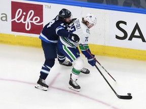Tyler Toffoli (73) of the Vancouver Canucks skates against Josh Morrissey (44) of the Winnipeg Jets during the third period in an exhibition game prior to the 2020 NHL Stanley Cup Playoffs at Rogers Place on July 29, 2020 in Edmonton, Alberta.