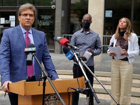 Coun. Kevin Klein (left) speaks while former police chief Devon Clunis and wife Pearlene wait during a press event outside City Hall to announce a community conversations series from Klein in Winnipeg on Thursday, June 18.