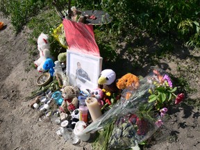 A makeshift memorial is set up on the banks of the Red River in Winnipeg near where nine-year-old Darius Bezecki drowned after falling into the Red River on Friday, July 3.