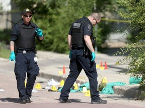Police investigate an incident on Main Street and Magnus Avenue on Tuesday, July 21. A 19-year-old British Columbia man has been arrested and charged with first-degree murder in connection with a shooting death of 31-year-old Cody Alexander Sleigh in Winnipeg in July after being located hiding out in Vancouver last week.