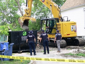 Police officers examine the scene with the use of an excavator on Tuesday, July 21, at a residence on Alfred Avenue in Winnipeg which was destroyed by fire and demolished on June 20, 2020. RCMP Major Crime Services investigators have now identified a location of interest at 381 Alfred Ave. in Winnipeg that may be linked to the homicide of Gerhard Reimer-Wiebe whose body was discovered in Portage la Prairie, Man., on June 24. Reimer-Wiebe's death was among the 43 homicides investigated in 2020.