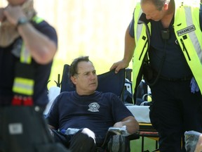 Fire crews cool off at a fire scene on Sherbrook. It was an extremely hot day in Winnipeg on Saturday.