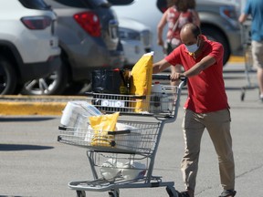 People walking through a parking lot, some wearing masks, in Winnipeg on Saturday.