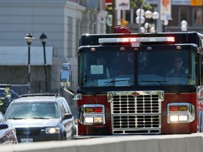 A fire truck heads north across the Osborne Street Bridge in Winnipeg on Sunday, July 26, 2020.