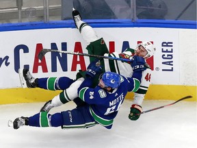 Jared Spurgeon #46 of the Minnesota Wild collides with Tyler Motte #64 of the Vancouver Canucks in Game One of the Western Conference Qualification Round prior to the 2020 NHL Stanley Cup Playoffs at Rogers Place on August 02, 2020 in Edmonton, Alberta, Canada.