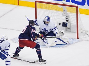 Pierre-Luc Dubois of the Columbus Blue Jackets backhands the game-winning goal past Frederik Andersen of the Toronto Maple Leafs during the first overtime period.