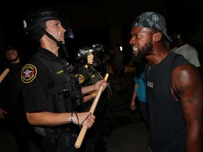 A man confronts police outside the Kenosha Police Department in Kenosha, Wisconsin, during protests following the police shooting of Black man Jacob Blake Aug. 23, 2020.