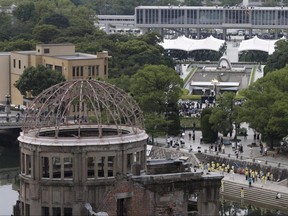 The Atomic Bomb Dome is seen in front of the venue holding a ceremony to mark the 75th anniversary of the atomic bombing, at the Hiroshima Peace Memorial Park in Hiroshima, Japan, Thursday, Aug. 6, 2020.