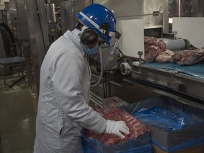 Workers inside the Maple Leaf processing plant in Brandon, Man. The Brandon Maple Leaf processing plant reported on Friday, Aug. 7, 2020, that there are now 10 positive cases of COVID-19 among the workers at the facility.