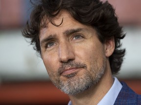 Prime Minister Justin Trudeau listens to a question as he speaks with media following an announcement in Brockville, Ont., Friday, Aug. 21.