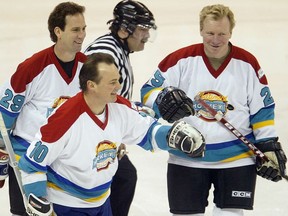 Former Jets Scott Arniel (left), Dale Hawerchuk (centre) and Thomas Steen share a light moment during an Old Time Hockey challenge charity game. Hawkerchuk died of cancer on Tuesday.