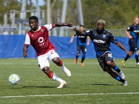 Valour FC midfielder Raphael Ohin (left) controls the ball while being marked by Edmonton FC attacker Hanson Boakai (right) on Saturday during Canadian Premier League Island Games soccer action in Charlottetown. Valour FC won 2-1.