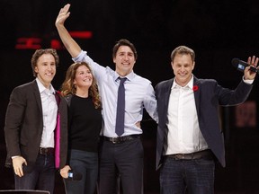 Prime Minister Justin Trudeau and his wife Sophie Gregoire-Trudeau are flanked by We Day co-founders Craig Kielburger, left, and Marc Kielburger, right.
