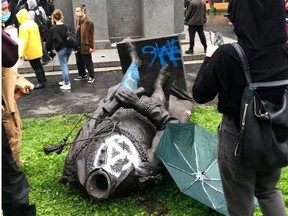 Statue of John MacDonald is seen on the ground after it was pulled down during a protest against racial inequality, in Montreal, Quebec, Canada August 29, 2020 in this picture obtained from social media.