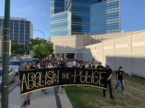 Approximately 100 people marched from the Winnipeg Remand Centre to police headquarters on Monday evening in support of the Elizabeth Fry Society, which advocates for women in the justice system. James Snell/Postmedia