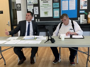 Good Neighbours lawyer, Kenneth Muys (left) and John Feldsted, chairman of the Good Neighbours Facility Working Group Committee (right) address the media, staff, and concerned residents at the Bronx Park Community Centre. James Snell/Postmedia