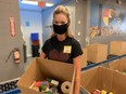 Sarah Scott, enterprise account executive with Rogers Communications helping out at Winnipeg Harvest on Thursday, Aug. 6, 2020. James Snell/Winnipeg Sun