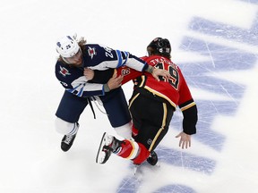 Blake Wheeler of the Winnipeg Jets and Matthew Tkachuk of the Calgary Flames fight in Game One of the Western Conference Qualification Round prior to the 2020 NHL Stanley Cup Playoffs at Rogers Place on August 1, 2020 in Edmonton, Alberta.