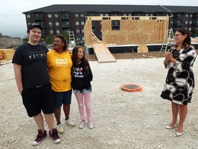 Soon-to-be homeowner Dawn-Marie Kerr (centre left), with children Donovin, 22, and Allissa, 14, are joined by Families Minister Heather Stefanson (right) after a press conference to announce funding for social housing at a Habitat for Humanity build on Templeton Avenue in Winnipeg on Thurs., Aug. 13, 2020. Kevin King/Winnipeg Sun/Postmedia Network