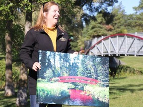 Manitoba Conservation and Climate Minister Sarah Guillemard announces the completion of the relocation of King's Park's iconic red bridges to Whiteshell Provincial Park on Friday.