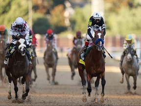 Jockey John Velazquez aboard Authentic, right, celebrates after winning the 146th running of the Kentucky Derby at Churchill Downs on Sept. 5, 2020 in Louisville, Kentucky.