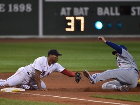 Boston Red Sox third baseman Rafael Devers, left, tags out Toronto Blue Jays designated hitter Rowdy Tellez during the seventh inning at Fenway Park in Boston, Mass., Sept. 5, 2020.