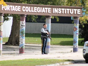 An armed RCMP officer positioned at the south entrance to Portage Collegiate Institute in Portage la Prairie, Man., after a threat was made against the school Wednesday morning.