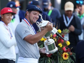 American Bryson DeChambeau celebrates with the championship trophy after winning the 120th U.S. Open on Sunday.