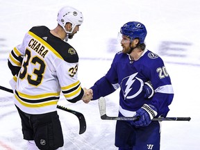 Blake Coleman of the Tampa Bay Lightning (right) shakes hands with Zdeno Chara of the Boston Bruins after the Lightning's 3-2 victory during the second overtime period in Game 5 of their second-round playoff series on Tuesday night in Toronto.