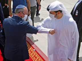 Israeli National Security Adviser Meir Ben-Shabbat elbow bumps with an Emirati official ahead of boarding the plane before leaving Abu Dhabi, United Arab Emirates, Sept. 1, 2020.