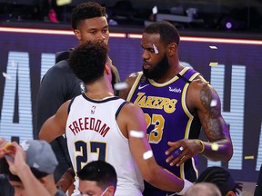 LeBron James of the Los Angeles Lakers hugs Jamal Murray of the Denver Nuggets after their win in Game 5 of the Western Conference Finals at AdventHealth Arena at the ESPN Wide World Of Sports Complex on September 26, 2020 in Lake Buena Vista, Florida.