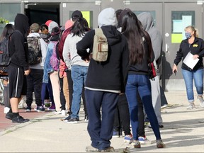 Students queue outside Gordon Bell High School on the first day back in Winnipeg on Tuesday, Sept. 8. A letter has been sent to parents about a possible exposure at Gordon Bell High School on Borrowman Place on Sept. 17 in the morning and afternoon, officials said.