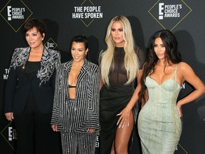(FILES) In this file photo taken on November 10, 2019 (L-R) Business women/media personality Kris Jenner, Kourtney Kardashian, Khloé Kardashian and Kim Kardashian arrive for the 45th annual E! People's Choice Awards at Barker Hangar in Santa Monica, California. - Fans will have to find another way to keep up with the Kardashians, as the mega-celebrity family announced on September 8, 2020 that their reality show will end next year. "It is with heavy hearts that we've made the difficult decision as a family to say goodbye to Keeping Up with the Kardashians," Kim Kardashian wrote in a post to her 188 million Instagram followers. (Photo by Jean-Baptiste Lacroix / AFP)
