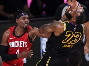 LeBron James of the Los Angeles Lakers is defended by Danuel House Jr. (left) of the Houston Rockets at AdventHealth Arena at the ESPN Wide World Of Sports Complex on September 6, 2020 in Lake Buena Vista, Florida.